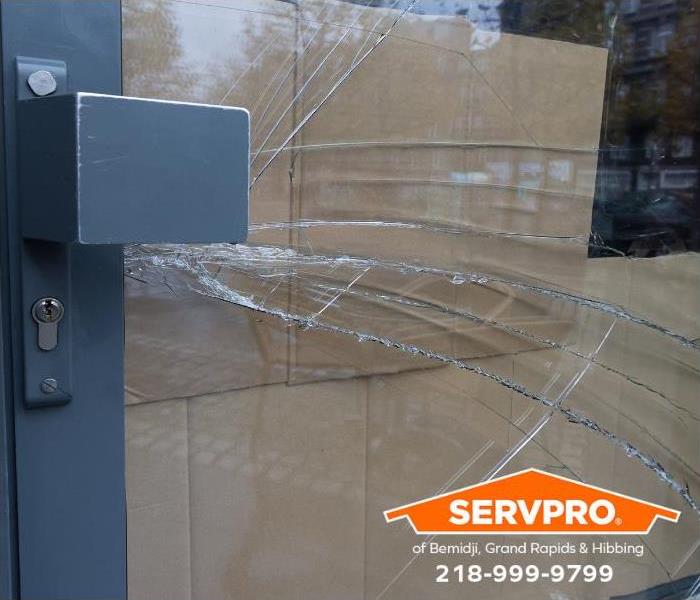 A door to a commercial business has broken glass.