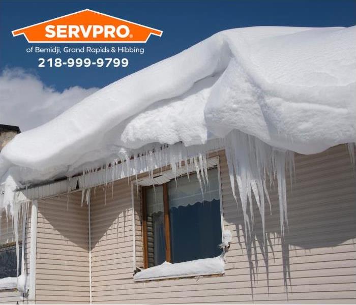 Heavy snow and ice dams dominate the roof of a residence.